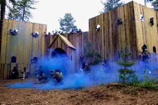 Wooden fort and buildings under smoke on The Village battlefield